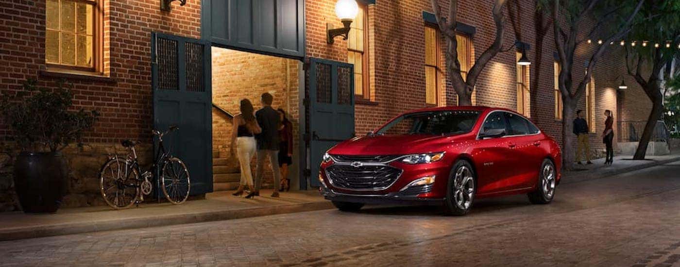 A red 2019 Chevy Malibu is shown from the front at an angle.