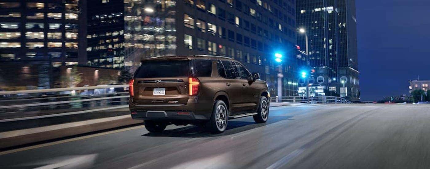 A brown 2022 Chevy Tahoe RST is shown from the rear at an angle.