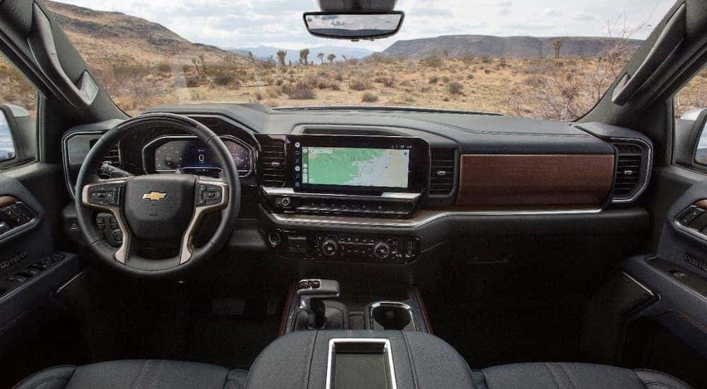 The black interior of a 2022 Chevy Silverado 1500 High Country as seen from above the center console.