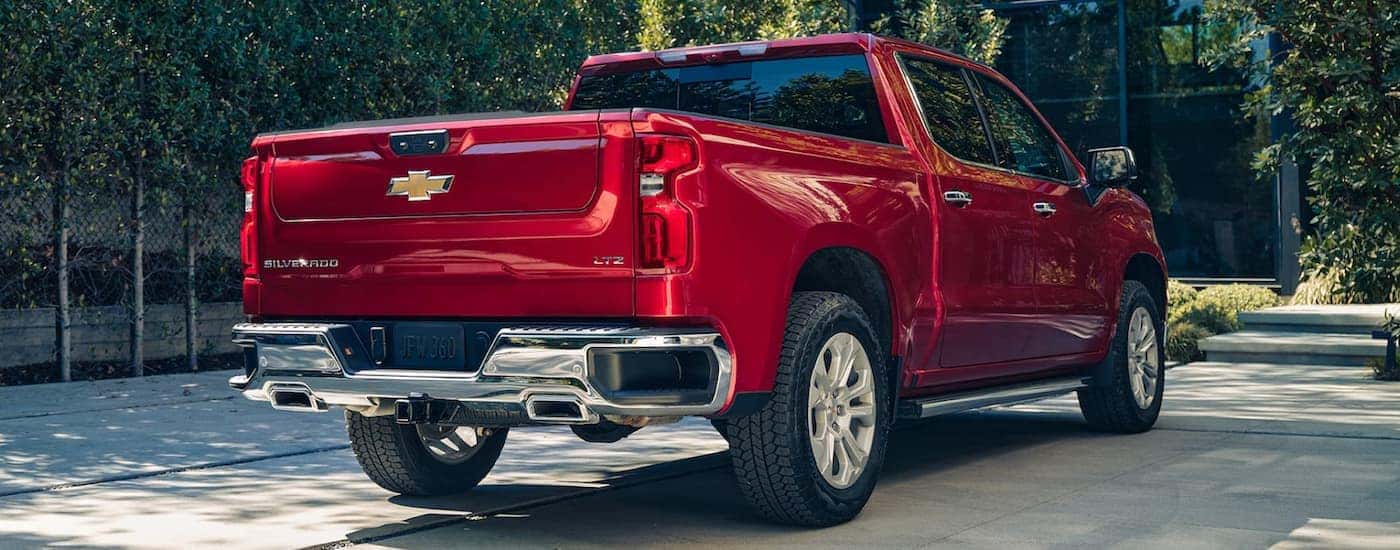 A red 2023 Chevy Silverado 1500 is shown from the rear.