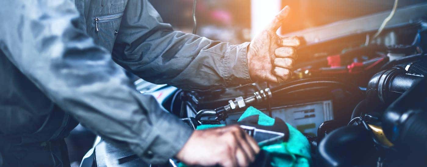 A mechanic is shown giving a thumbs up.