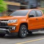 An orange 2021 Chevy Colorado Z71 speeding down a city street