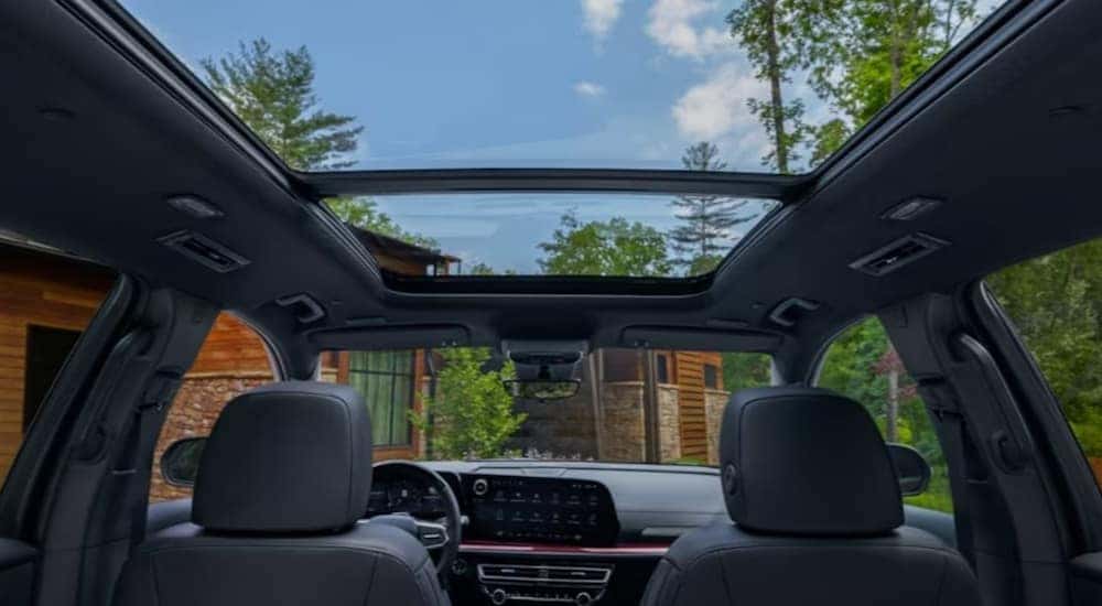 View from the interior of a 2024 Chevy Traverse, looking up through the panoramic sunroof