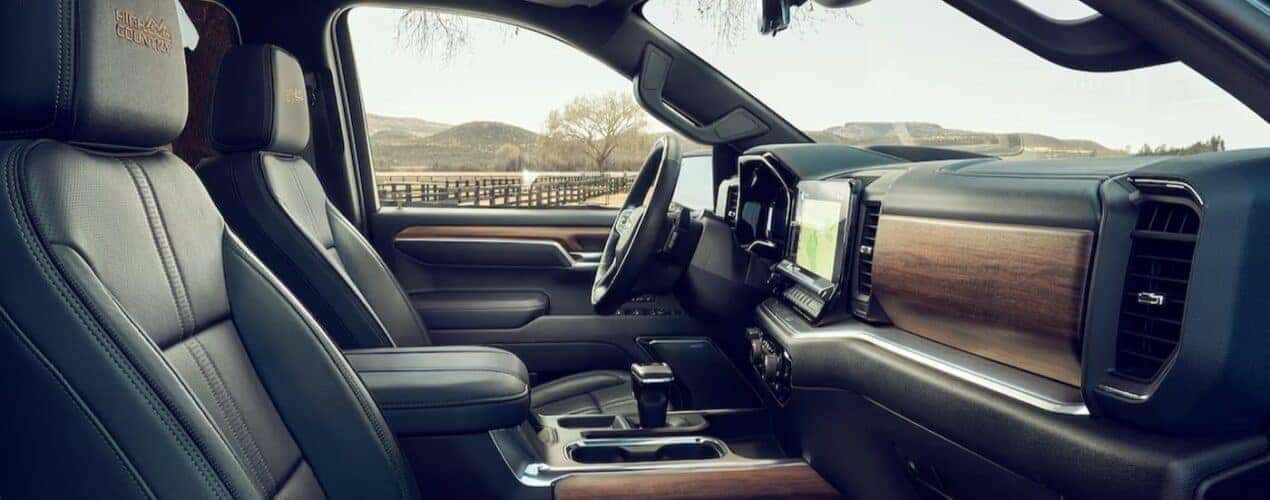 The black and brown interior and dash of a 2024 Chevy Silverado 1500 High Country is shown.