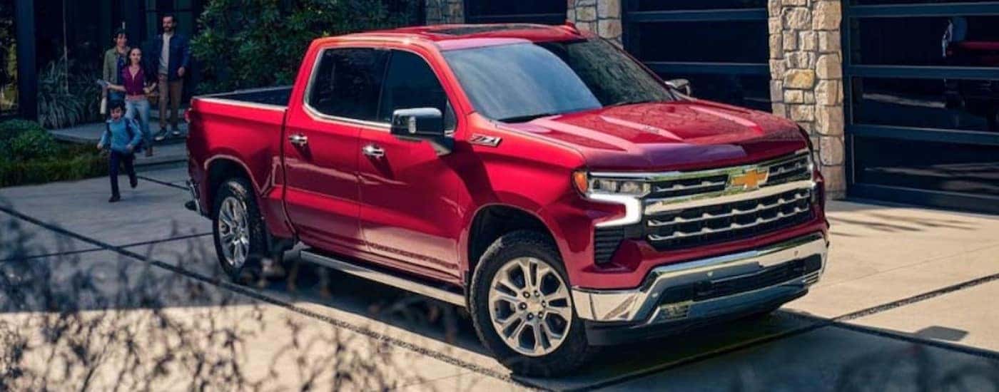 A red 2024 Chevy Silverado 1500 Z71 is shown parked on a driveway.