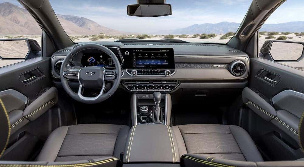 The front seats and dashboard in a 2024 Colorado, one of many Chevys for sale near Bowling Green.