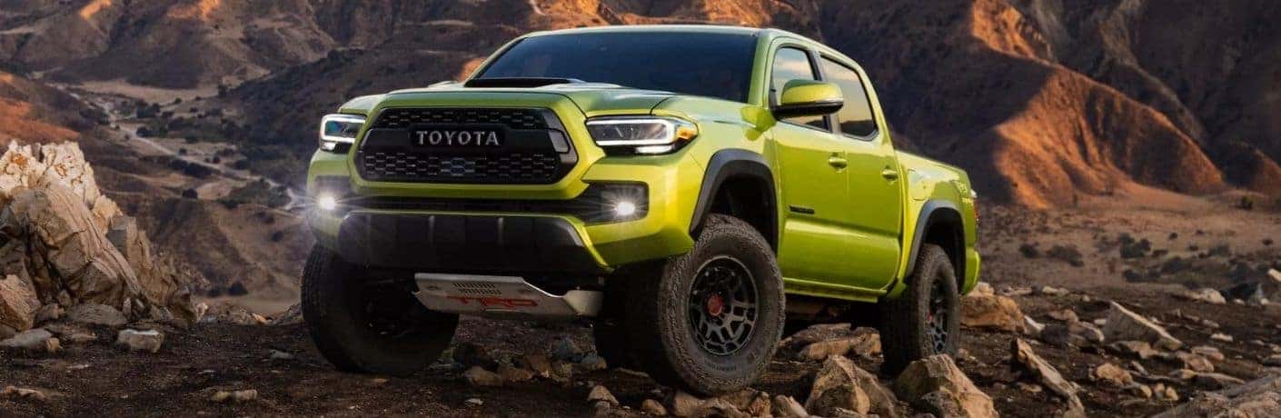 Electric Lime Metallic 2022 Toyota Tacoma TRD Pro Front Exterior on Rocky Trail