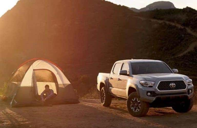 Gray Used Toyota Tacoma Next to a Tent