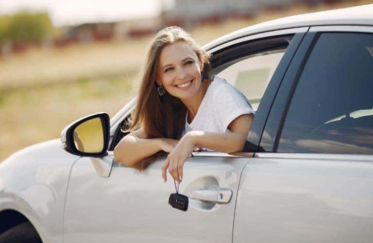 Woman in White Car with Keys