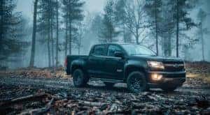 A black 2018 Chevy Colorado Z71 is shown parked on a foggy trail.