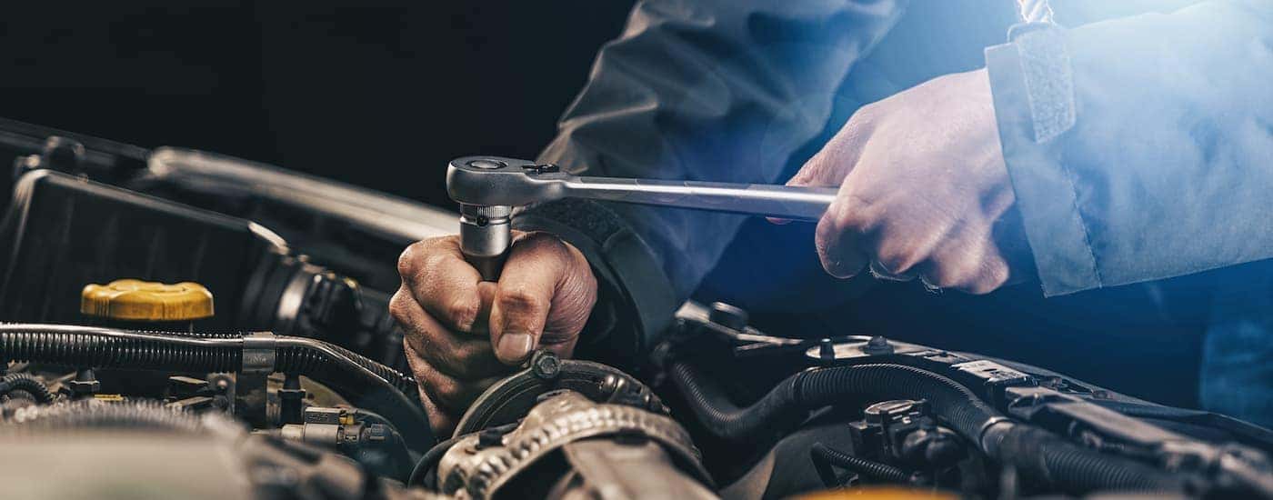 A mechanic is shown working on a vehicle at a truck dealership near you.