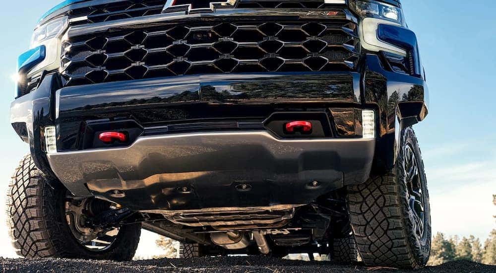 A close up of the front of a blue 2023 Chevy Silverado 1500 ZR2 is shown from a low angle.