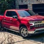 A red 2023 Chevy Silverado 1500 Z71 is shown parked in a driveway.