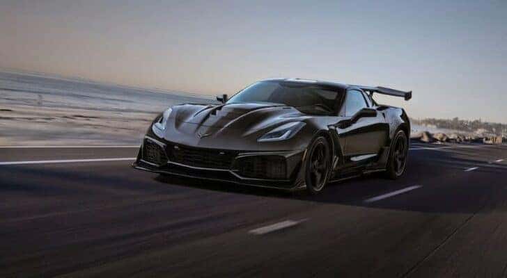 A black 2019 Chevy Corvette ZR1 is shown driving on a highway after visiting a Dover Plains Chevy dealer.