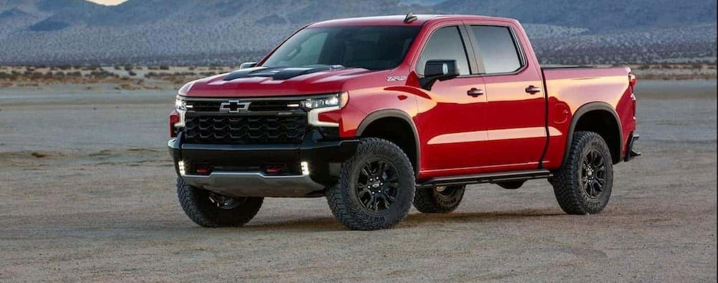 A red 2022 Chevy Silverado ZR2 is shown parked off-road.