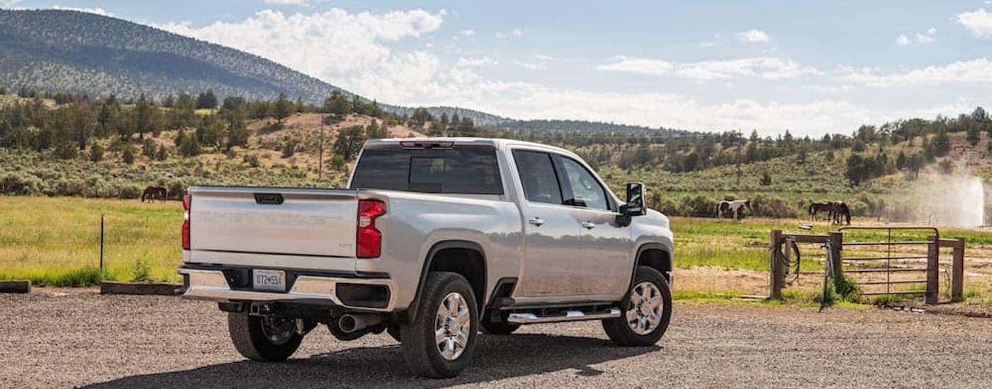 A silver 2022 Chevy Silverado 2500HD is shown from the rear at an angle.