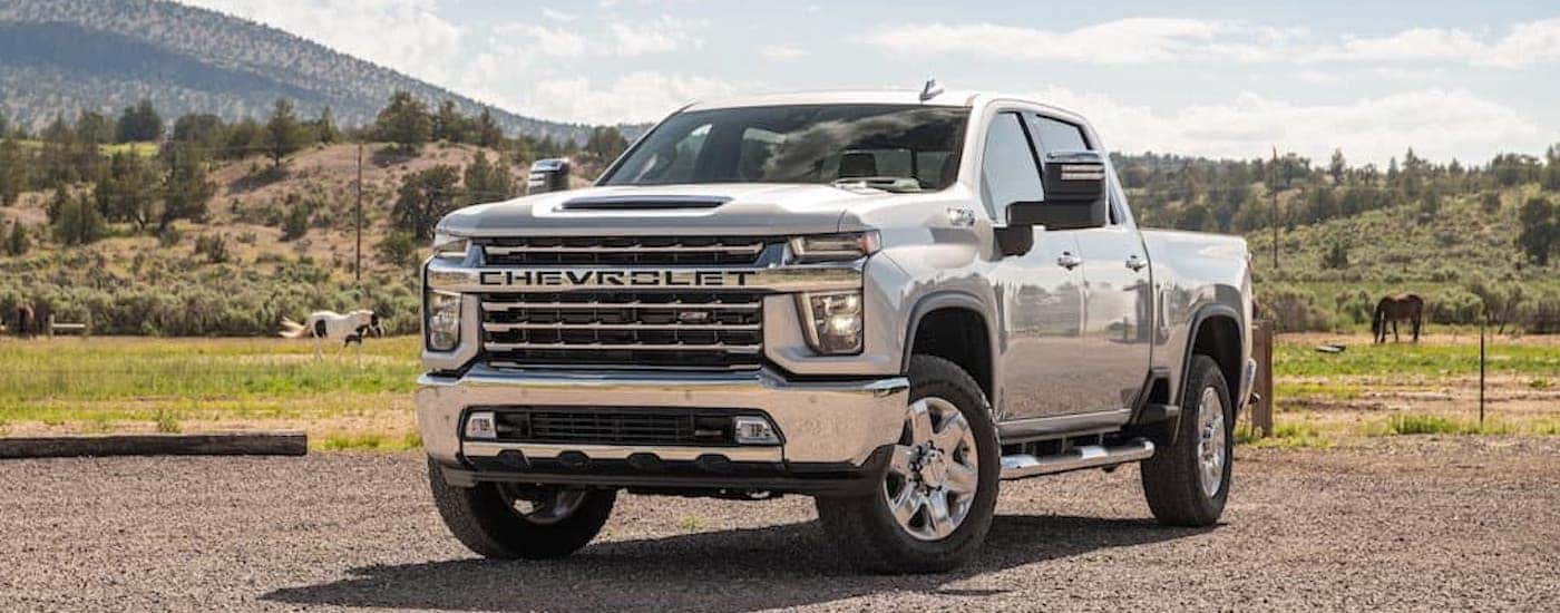A silver 2022 Chevy Silverado 2500 HD is shown from the front at an angle after leaving a dealer that has Chevy trucks for sale near Red Hook.