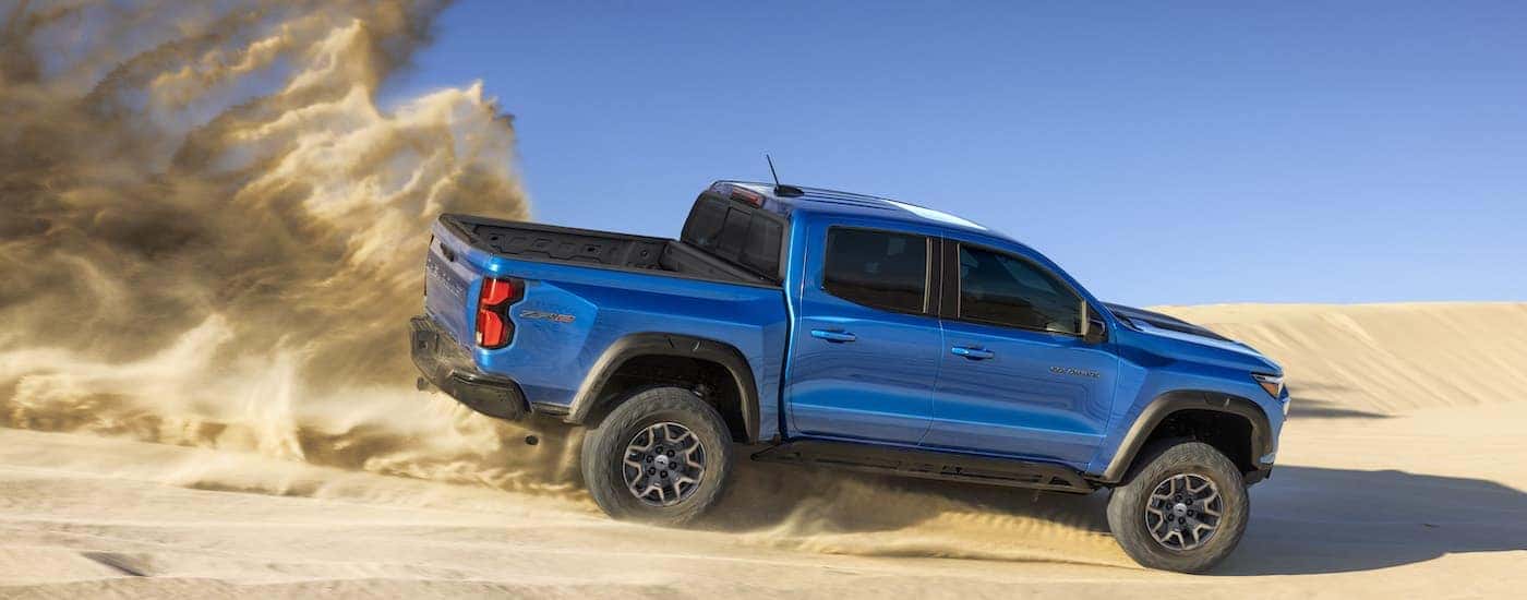 A blue 2023 Chevy Colorado ZR2 is shown from the side while off-road.