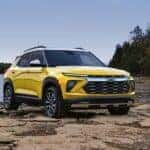 A yellow 2024 Chevy Trailblazer is shown parked off-road near a lake after visiting a Chevy dealer near Mount Kisco.