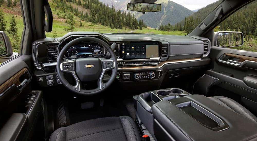 The black interior of a 2024 Chevy Silverado 1500 for sale near Pleasant Valley is shown from the driver's seat.