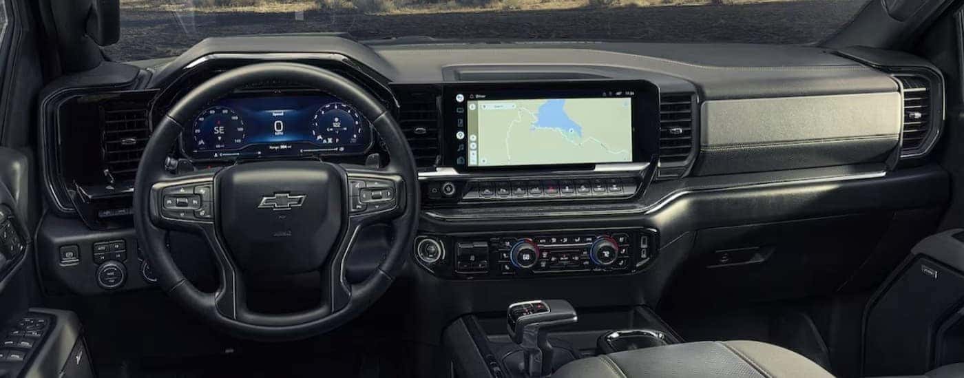 The black interior and dash in a 2024 Chevy Silverado 1500 for sale near Pleasant Valley is shown.