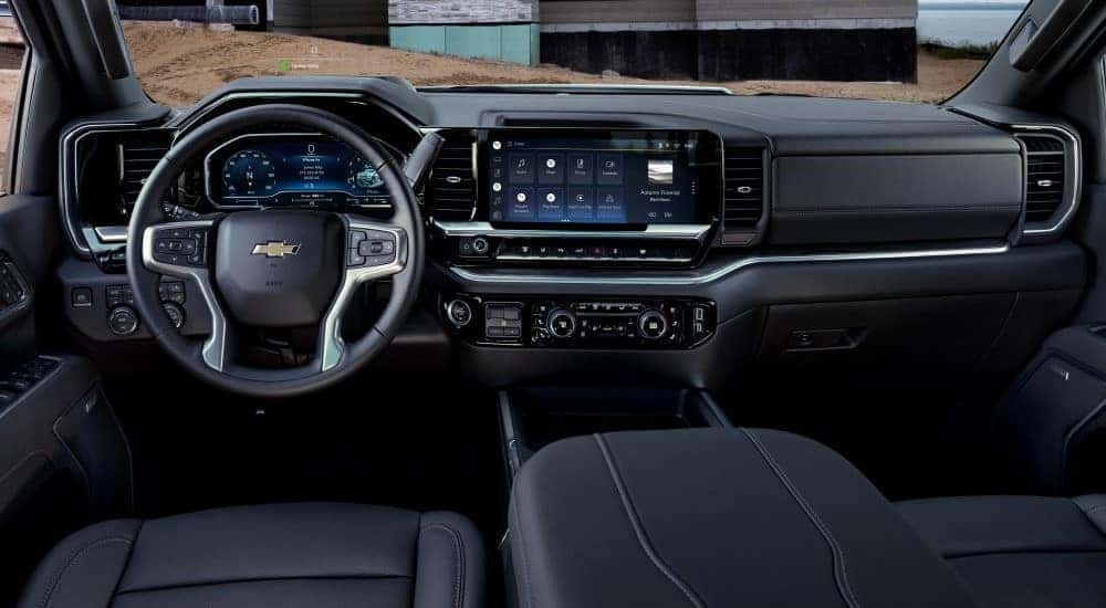 The black interior and dash in a 2024 Chevy Silverado 3500 for sale is shown.