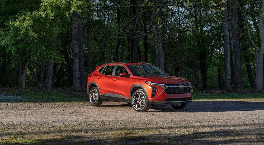 An orange 2024 Chevy Trax for sale is shown from the front at an angle.
