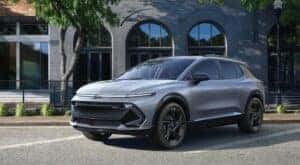 A silver 2025 Chevy Equinox EV RS is shown parked.