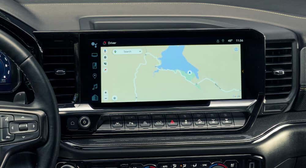 A close-up of the infotainment screen is shown in a 2025 Chevy Silverado 1500 for sale in Millbrook.