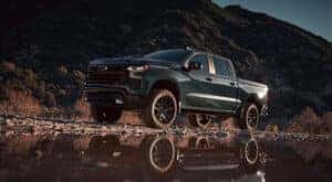 A black 2025 Chevy Silverado 1500 for sale in Millbrook is shown off-road.