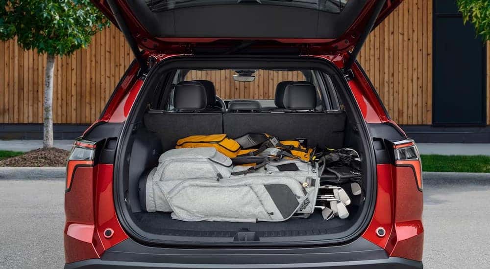 The open hatchback of a red 2025 Chevy Equinox.