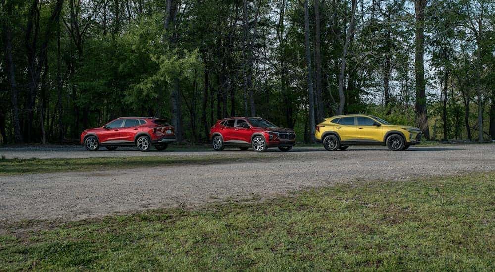 Three 2025 Chevy Trax for sale near Poughkeepsie parked in a forest.