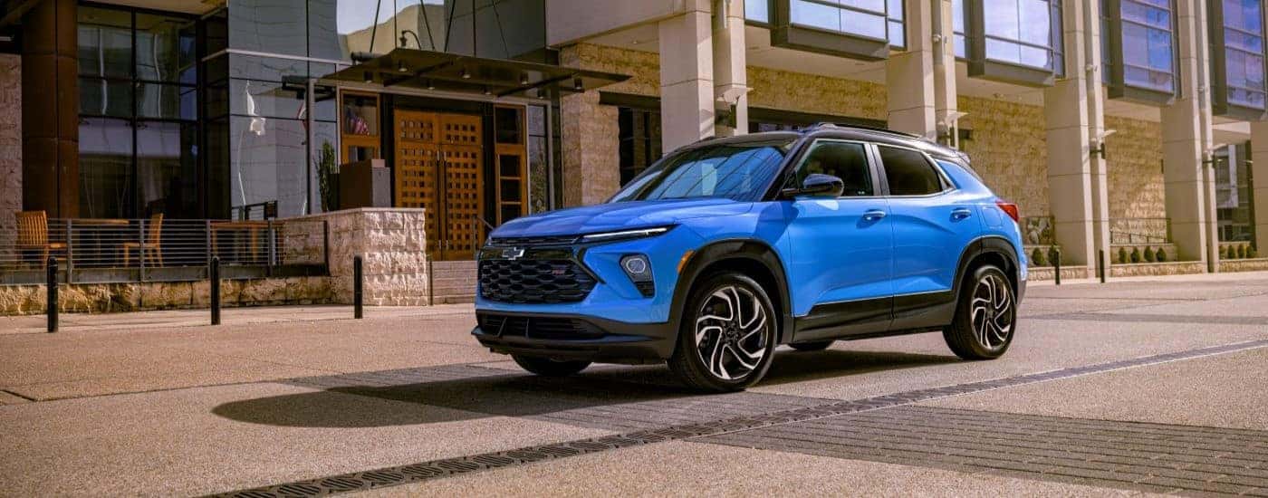 A blue 2024 Chevy Trailblazer RS is shown parked near a Chevy dealer near Patterson.