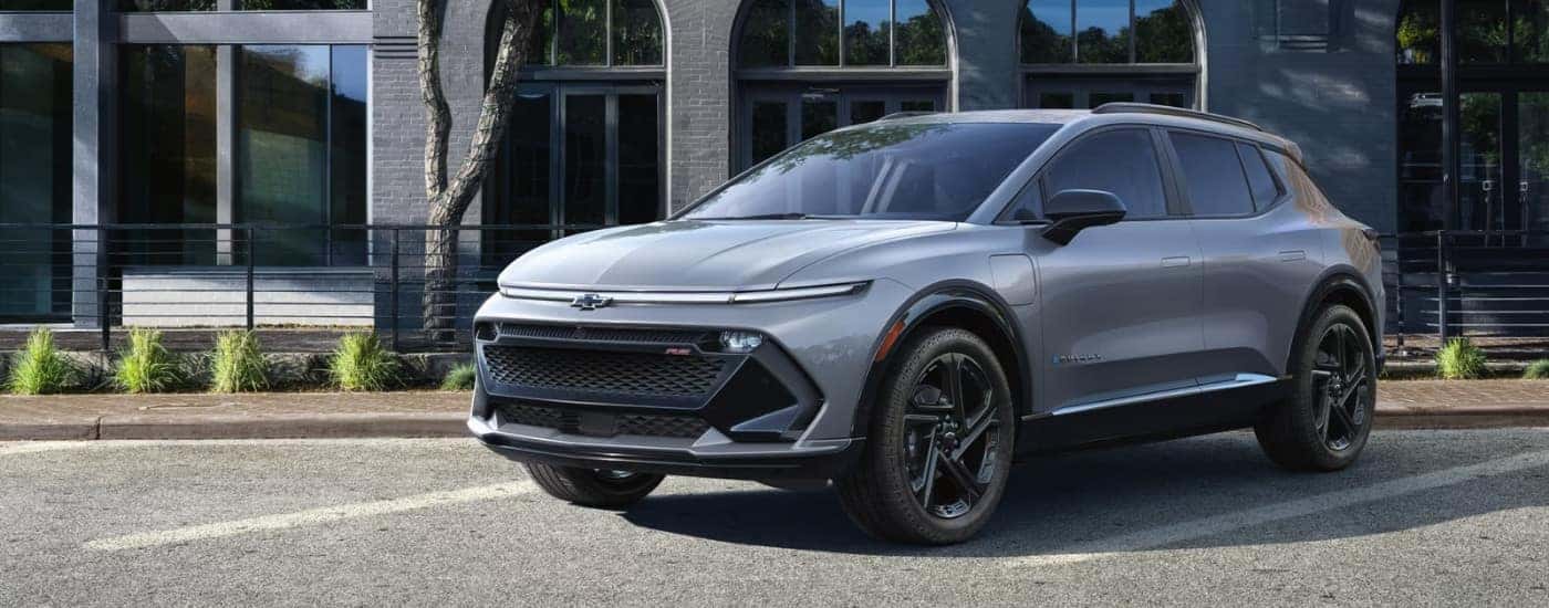 A silver 2025 Chevy Equinox EV RS is shown parked.