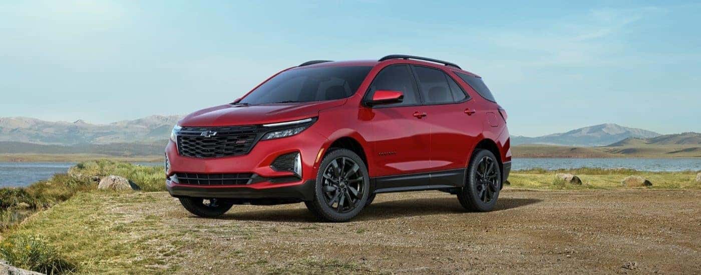 A red 2022 Chevy Equinox RS is shown from the front at an angle after leaving a dealer that has a Chevy Equinox for sale.