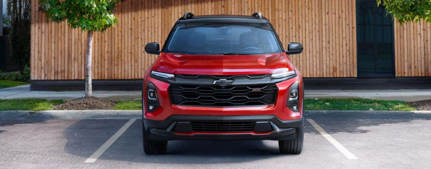 A red 2025 Chevy Equinox RS is shown parked after viewing a Chevy Equinox for sale in Millbrook.
