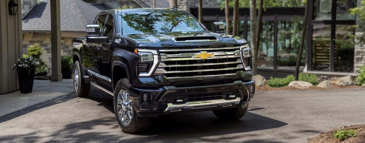 A black 2024 Chevy Silverado 2500 for sale is shown from the front at an angle.