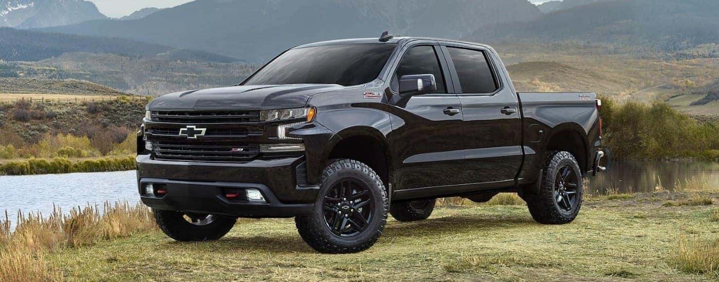 A black 2021 Chevy Silverado 1500 Trail Boss is shown from the front at an angle.
