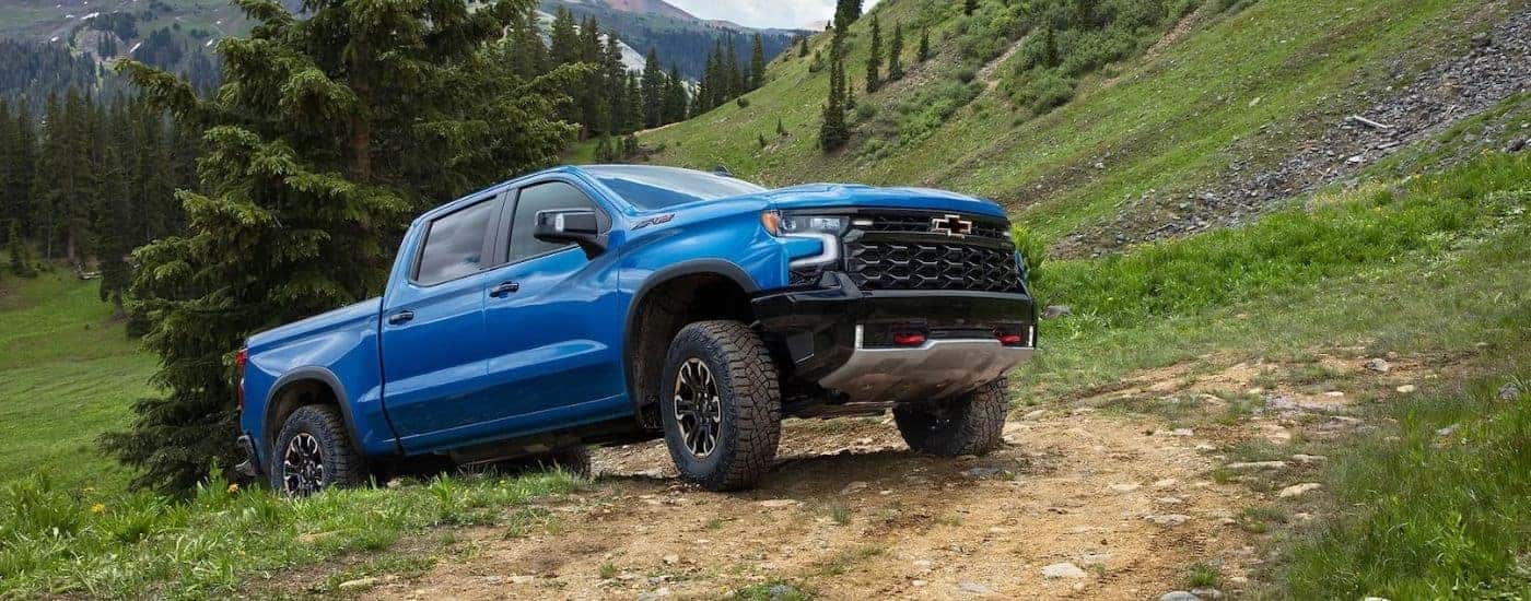 A blue 2022 Chevy Silverado 1500 ZR2 driving off-road.