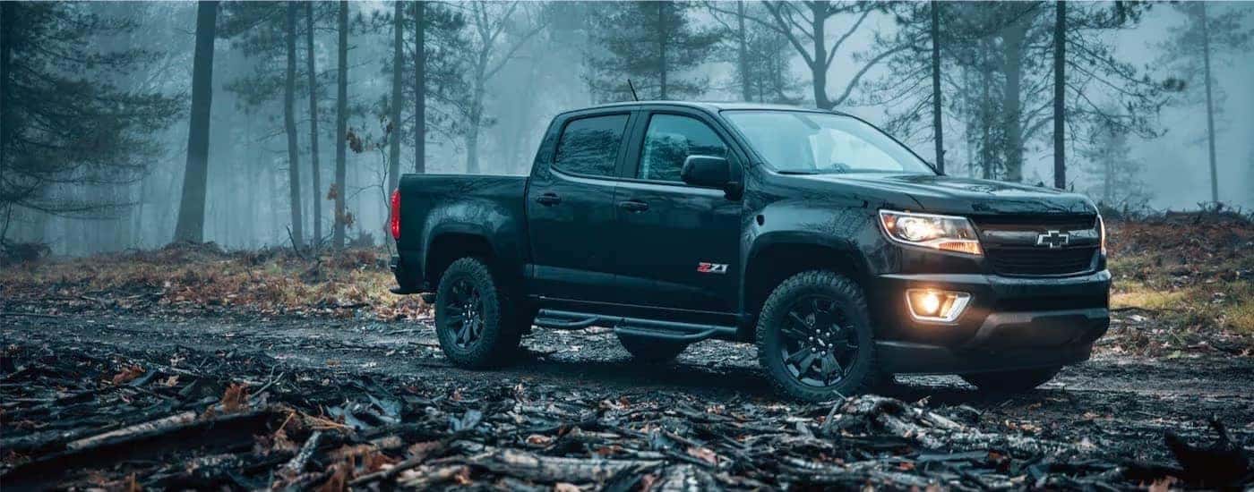 A black 2018 Chevy Colorado Z71 is shown parked on a foggy trail.