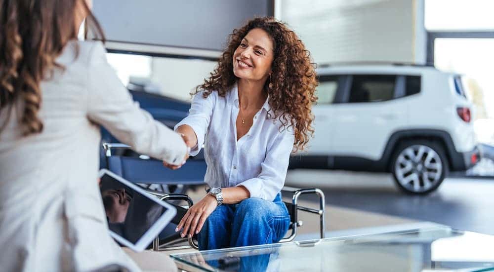 Two women shaking hands.
