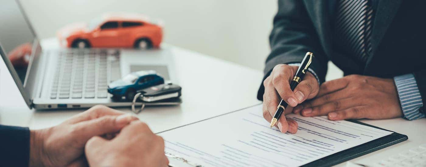 Filling out paperwork for selling us your vehicle