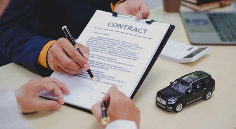A person signing a contract.