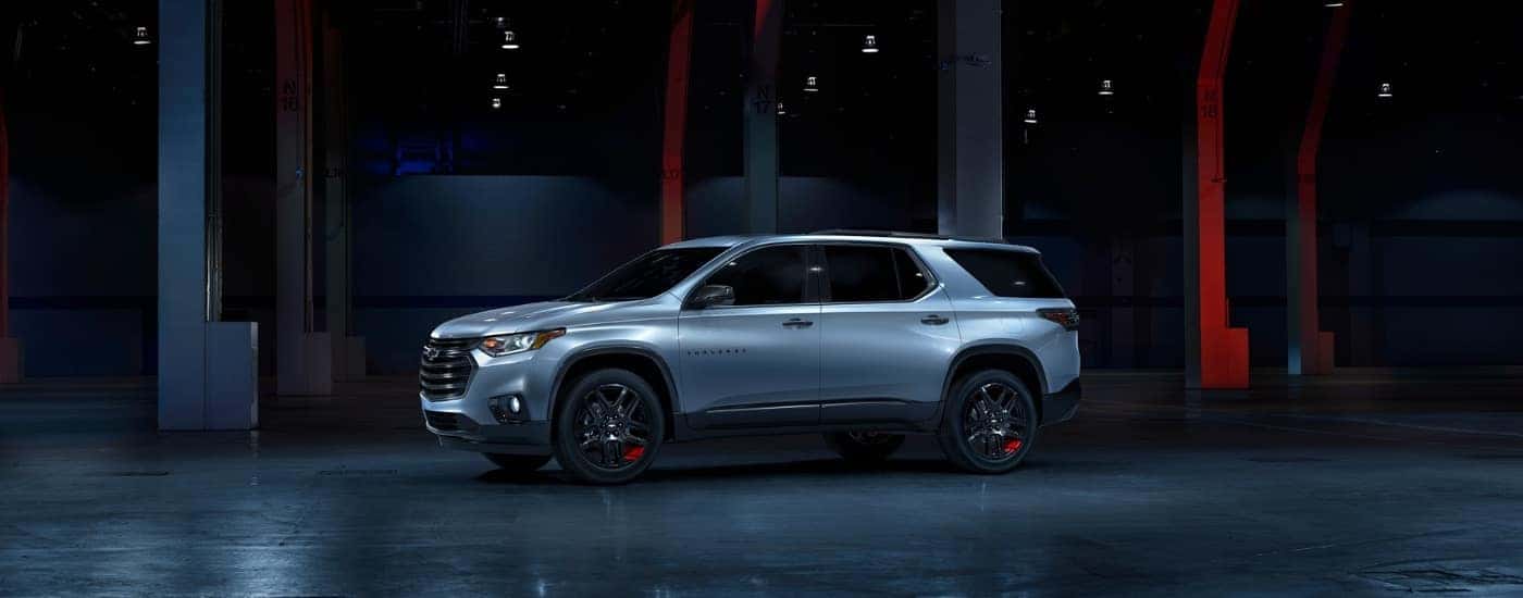 A silver 2018 Chevy Traverse Redline in a futuristic warehouse.