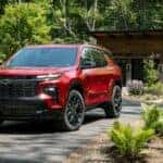 A red 2025 Chevy Traverse for sale from the front.