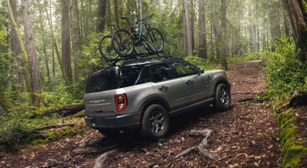 A silver used 2021 Ford Bronco Sport off-roading in the woods