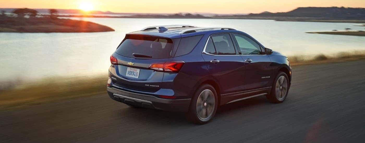 Rear of a dark blue 2022 Chevy Equinox near a lake.