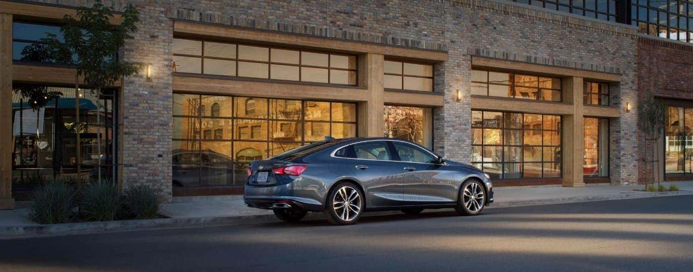 A grey 2019 Chevy Malibu from the side after leaving a used car dealer in Millbrook.
