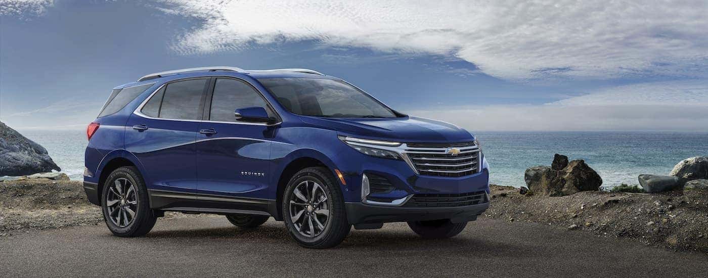 A blue 2023 Chevy Equinox from the side.