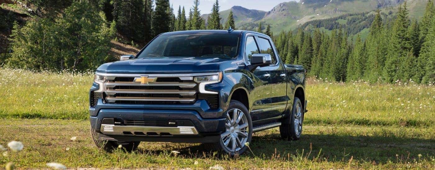 A blue 2024 Chevy Silverado 1500 from the front at an angle after leaving used car dealership near Poughkeepsie.